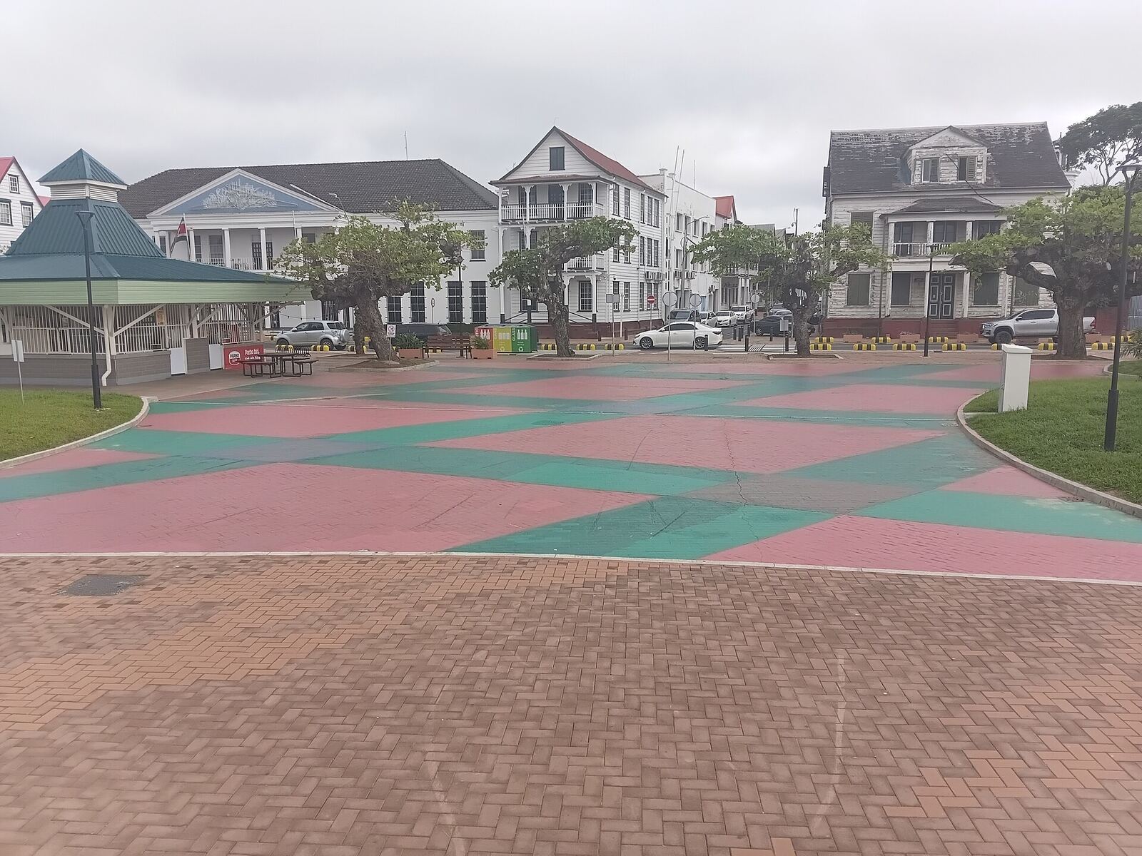 Red and green paved plaza beside colonial timber buildings on the renewed Waterfront, Paramaribo