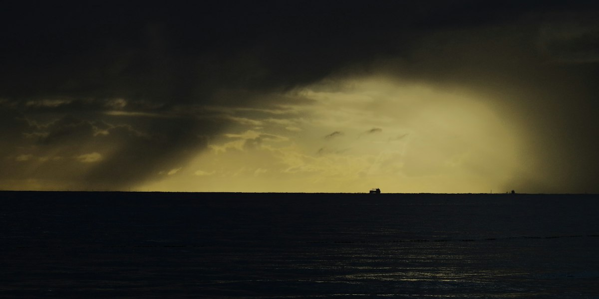 Dark storm clouds gathering over the Caribbean Sea at dusk during the 2026 Atlantic hurricane season